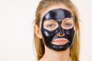 Girl black carbo peel off mask on face
