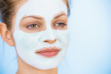 Girl with dry white mud mask on face