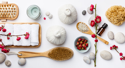 Spa treatment concept, flat lay composition with natural cosmetic products and massage brushes