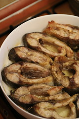 Fried carp fish slices on a ceramic plate, close up. Traditional christmas eve dish