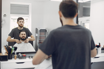 Fototapeta na wymiar Man with a beard. Hairdresser with a client.