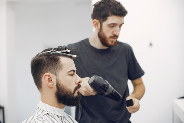 Man with a beard. Hairdresser with a client.