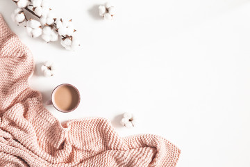 Cup of coffee, pink blanket, cotton flowers on white background. Flat lay, top view, copy space - 318502937