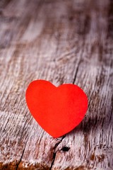 Red paper heart on a wooden background. Holidays. Valentine's Day.