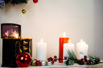 Music box, burning candles, still life on the fireplace new year
