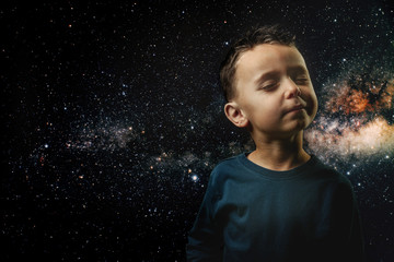 a small child imagines himself to be an astronaut in an astronaut's helmet.