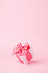 White gift box and on pink background with copy space for text. Luxury fashion, shopping sale...