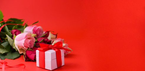 Women's day concept and Valentine's day greeting card. Composition with gift, roses. Space for text. Banner
