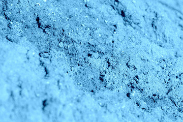 Construction sand texture close-up. Natural abstract background blue color toned