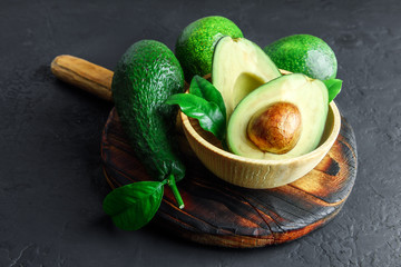 Fresh avocado fruit on a wooden board. The concept of healthy eating. Food photography