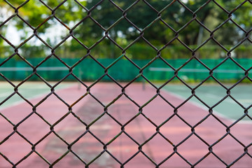 Fototapeta premium Metal fence and tennis court
