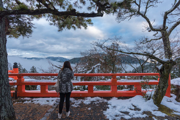 Woman looking view from Honden main hall at Mt.Kurama , Kyoto
