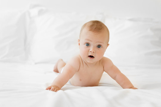 Cute baby lying on stomach with funny expression