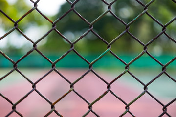 Fototapeta premium Metal fence and tennis court