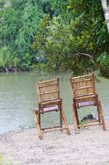 Fototapeta premium two chairs by the water
