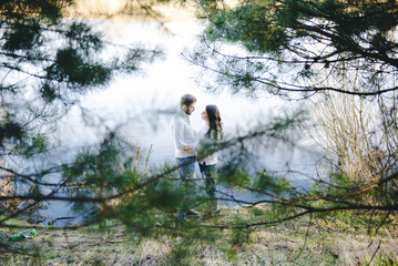 Obraz premium Happy girl and guy on the river, travel love story concept