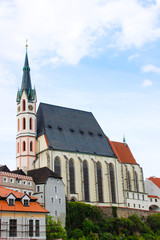 Fototapeta premium Vertical picture of the facade of St. Vitus Church in Cesky Krumlov, Czech Republic, during a sunny day