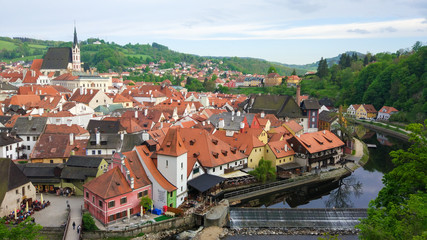Fototapeta na wymiar Aerial panoramic view of the typical colorful houses of Cesky Krumlov with Vltava river at the foreground and St. Vitus Church at the background (Czech Republic)