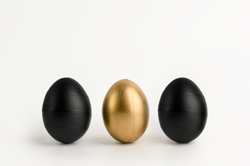 Three Easter golden and black decorated eggs isolated on white background. Line decorated. Minimal easter concept. Happy Easter card, copy space