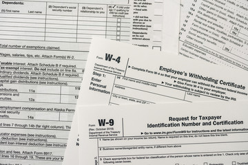 Fototapeta premium Paper blanks of 1040, w4 and w9 tax form close up