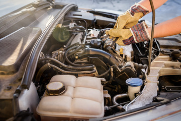 Hands with spanners and car engine close up. Car service concept