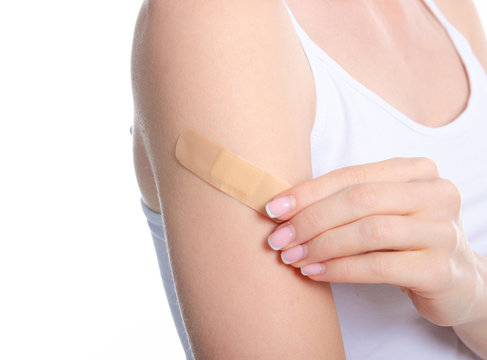 Woman shoulder hand with medical patch plaster on white background isolation