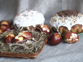 Easter baking with Easter eggs dyed with onion husks with imprints of fresh leaves, on a fabric canvas background. We meet Easter Sunday.