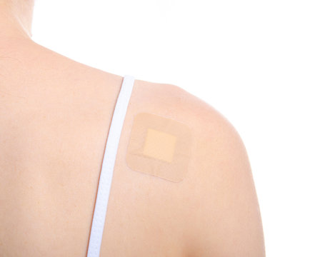Woman shoulder back hand with medical patch plaster on white background isolation