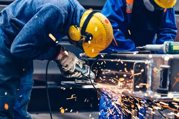 Fotobehang Worker grinding in a workshop. Heavy industry factory © Photocreo Bednarek