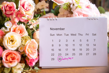 Wedding date anniversary calendar and flower bouquet (rose).Couple of love  planning a honeymoon...