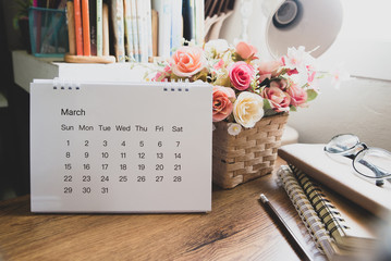 Planner and Calendar Concept.Desktop Calendar 2020,diary,white lamp and eyeglasses place on office desk.Notebook for Planner to set timetable,agenda and appointment.