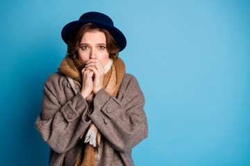 Photo of traveler lady have problems with cold weather unexpected frosty day blowing mouth warm to arms wear stylish casual long grey coat scarf hat isolated blue color background