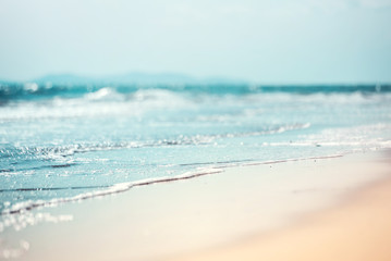 Close-up soft wave of the sea on the sandy beach - obrazy, fototapety, plakaty