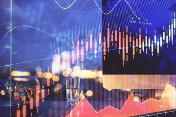 Financial graph colorful drawing and table with computer on background. Multi exposure. Concept of international markets.