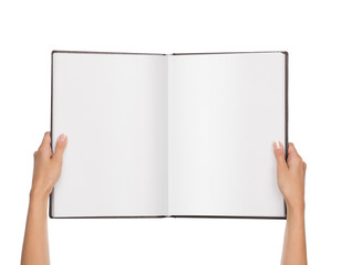 High angle view up of female hands holding blank open book isolated on white bakground  with copy...