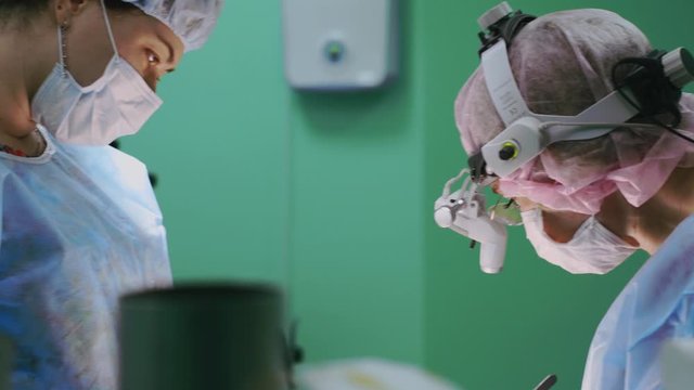 Modern medetsina, a team of surgeons makes an operation. Modern medical equipment allows surgeons to perform delicate and precise operations. Fight against oncology