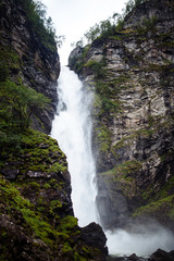 Obraz premium Norway landscape with big waterfall. Picturesque landscape mountains of Norway. Travelling, lifestyle, wild nature concept.