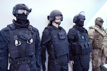 Mannequins in military and police camouflage with helmets, bulletproof vests and protective masks made of bulletproof glass