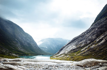 Picturesque landscape  mountains of Norway. Beautiful view of the lake. Rocky shore of mountain lake in the morning. Travelling, lifestyle,  wild nature concept.