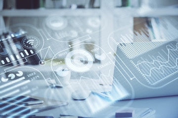 Computer on desktop in office with technology theme hologram. Multi exposure. Tech concept.