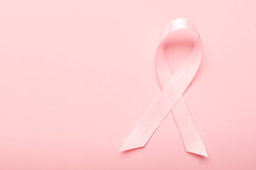 Pink ribbon on color background. Breast cancer awareness concept