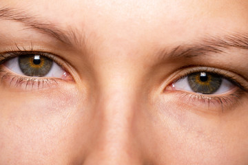 Fototapeta premium Gray, brown eyes, Sector heterochromia, looking at the camera. Portrait of a young woman, teenager