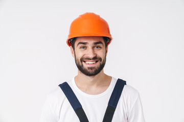 Man builder in helmet posing isolated