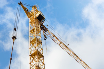 Construction, construction crane closeup on blue sky background. Place under the text, copy space.