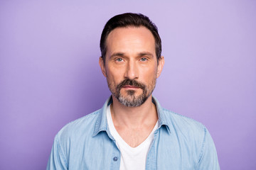 Portrait of serious masculine man freelancer good look wear stylish clothes isolated over violet color background