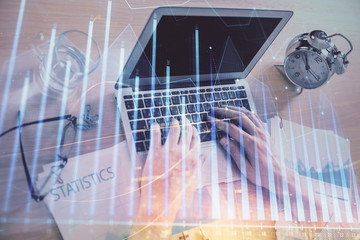Multi exposure of forex graph with man working on computer on background. Concept of market analysis.
