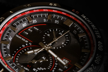 Fototapeta premium Luxury sport chronograph black Analog Men's Watch silver red steel for men luxury on black background - detail view