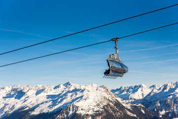 Fototapeta na wymiar Ski cable lift in the Alps. Austrian Alps ski resort.