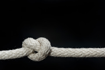 Sailor knot and rope isolated on a black background	