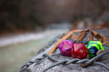Closeup DnD colorful dice with autumn leaves 